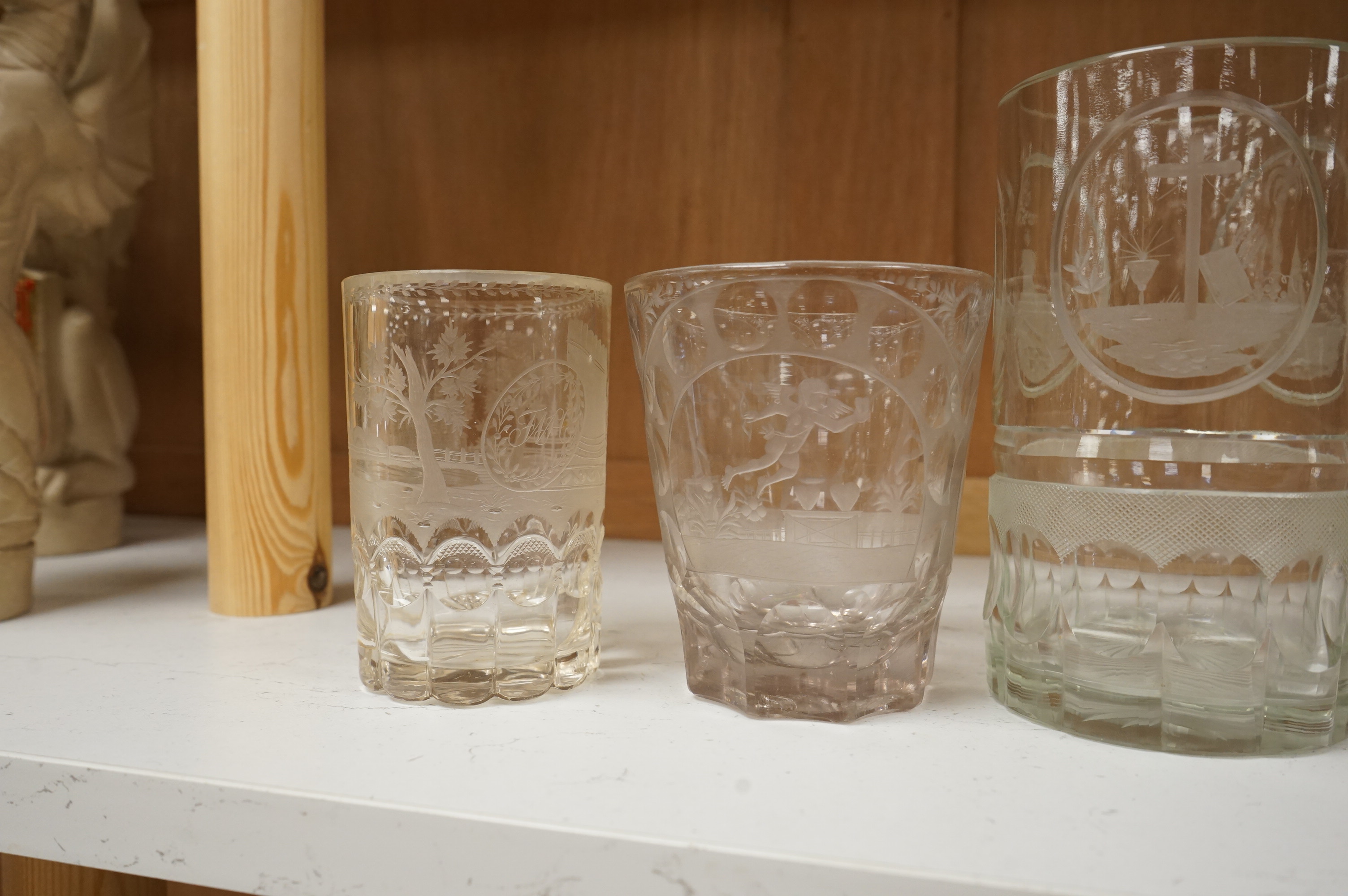Four German or Bohemian engraved glass beakers, 19th century, largest 16cm high